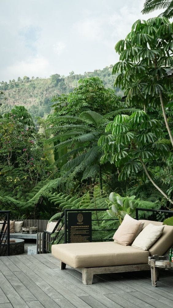 Outdoor lounge deck overlooking a lush jungle hillside